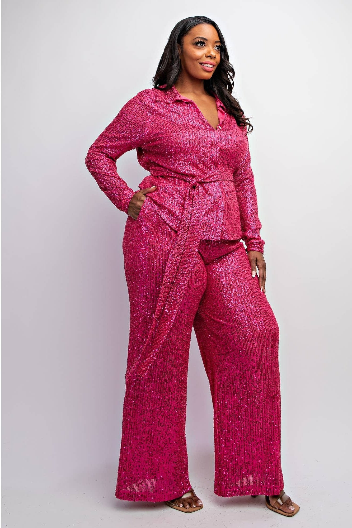 a woman in a pink jumpsuit posing for a picture