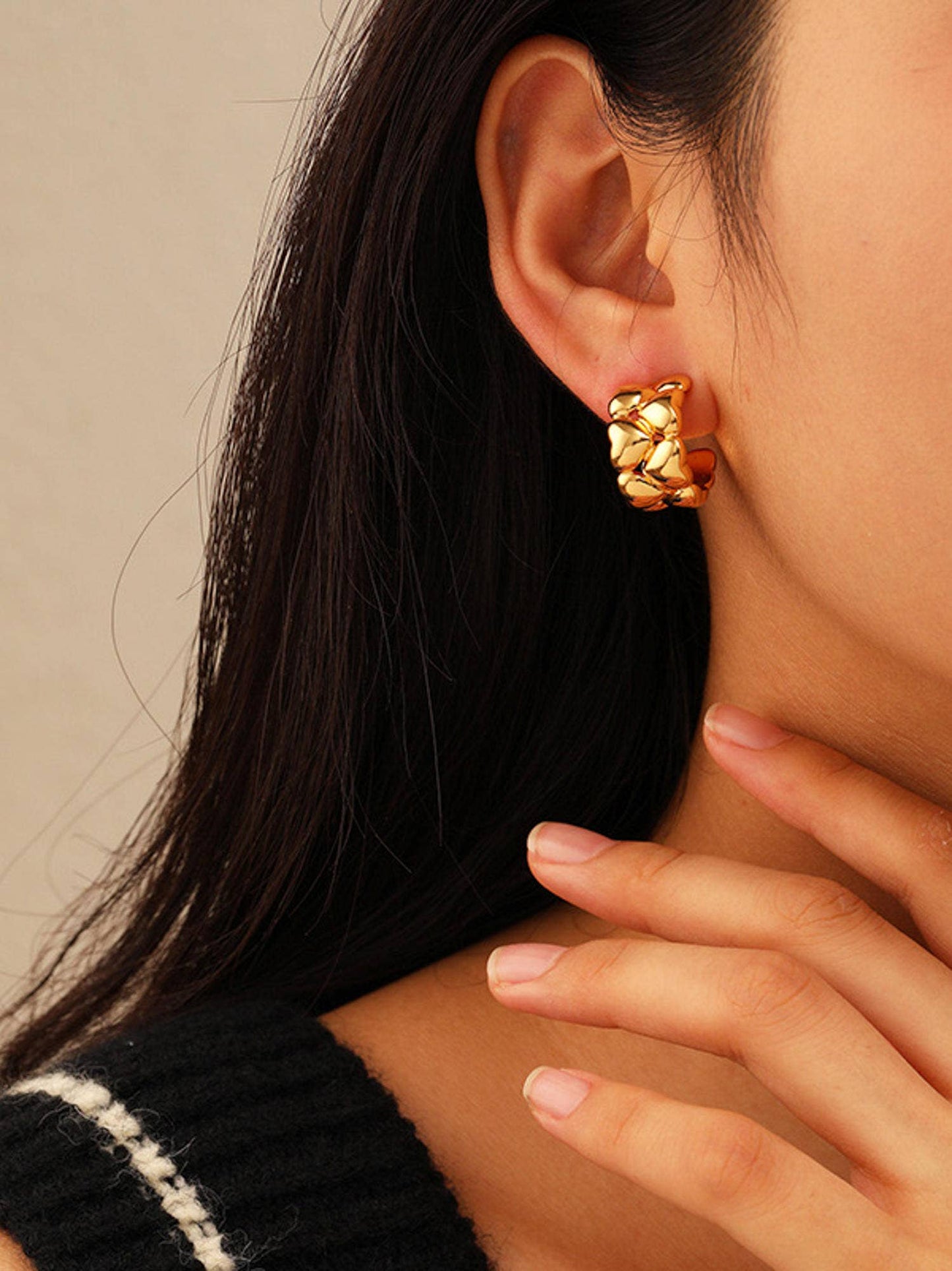 a close up of a person wearing a pair of earrings