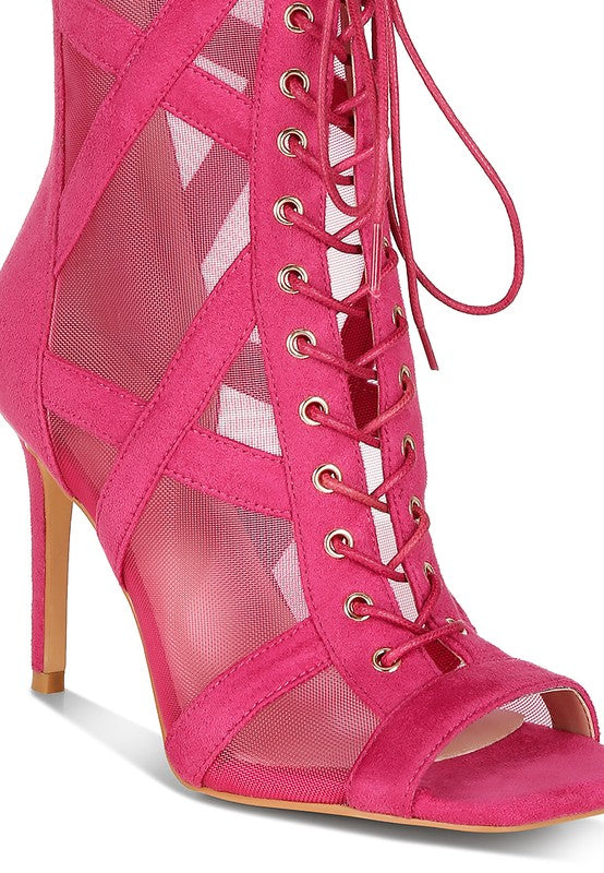 a pink high heeled shoe with a caged design