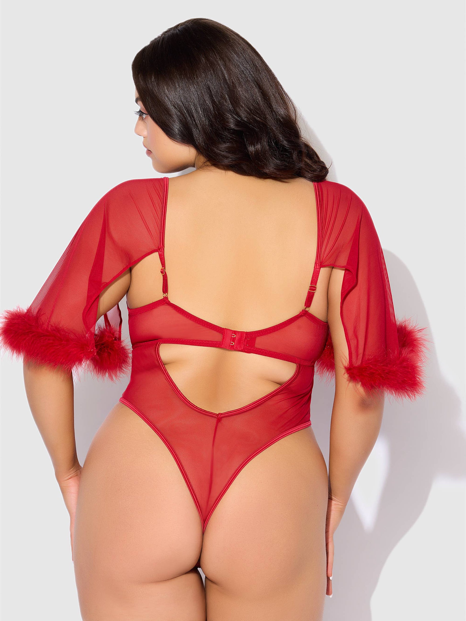 a woman in a red bodysuit with feathers