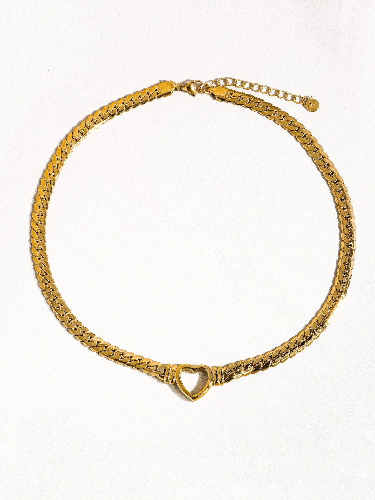 a gold bracelet with a heart on it