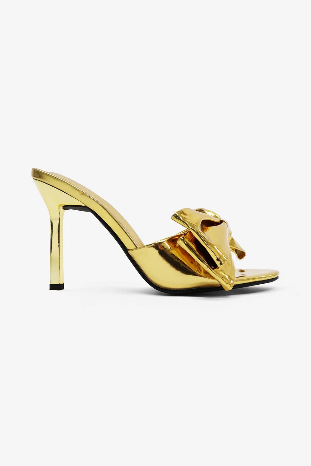 a gold shoe with a bow on the heel