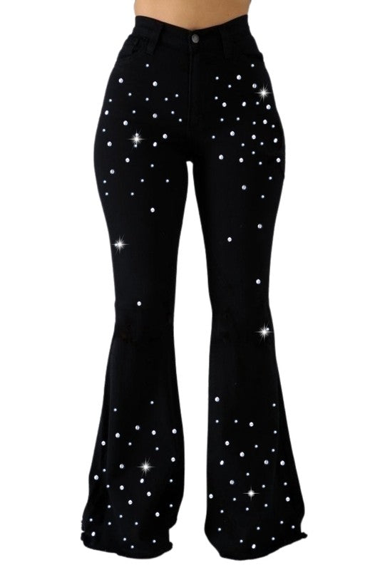 a woman in black pants with stars on them