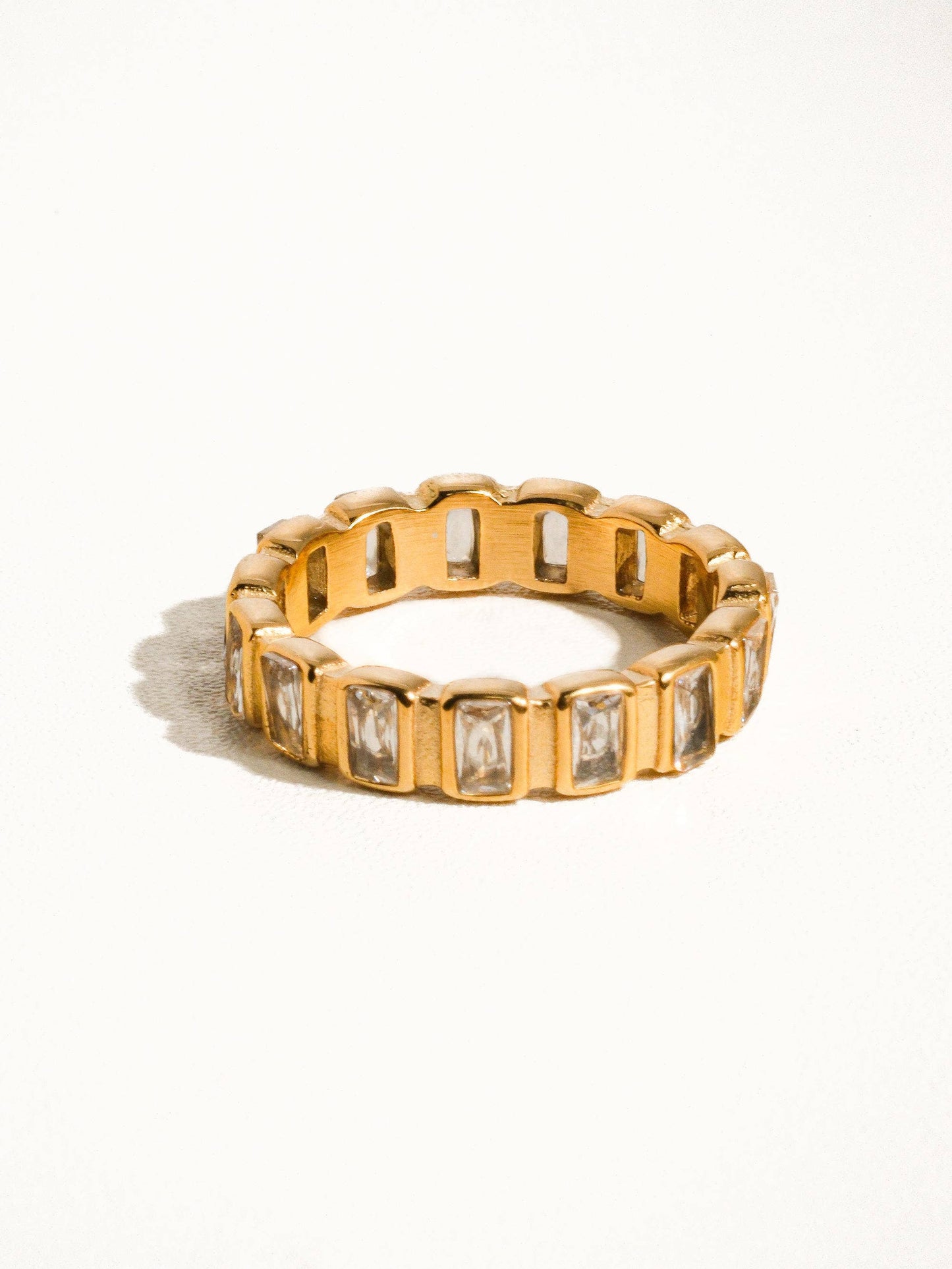 a yellow gold ring with baguets of diamonds