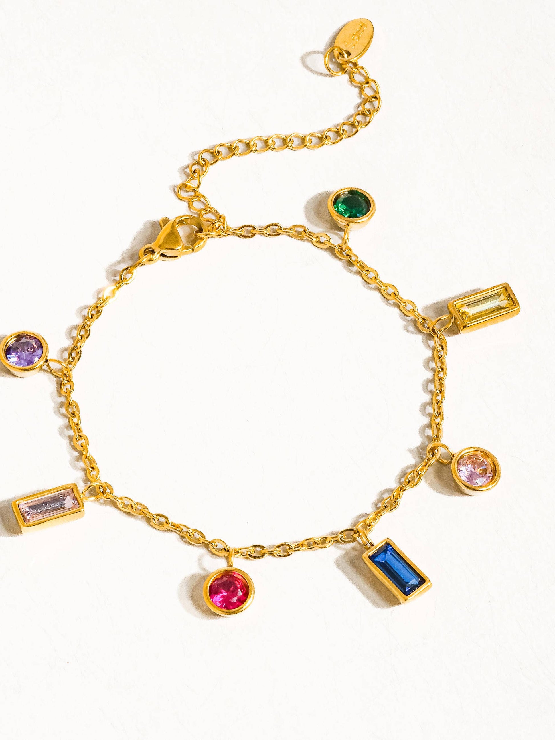 a gold bracelet with different colored stones