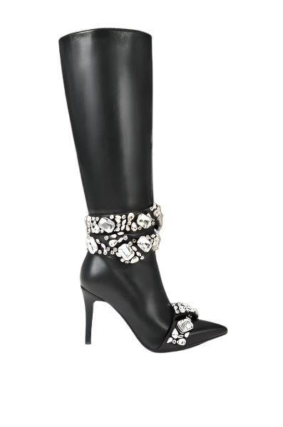 a pair of black high heeled boots with flowers