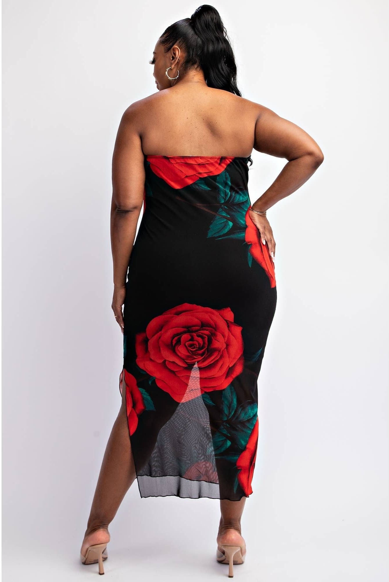 a woman wearing a black and red rose print dress