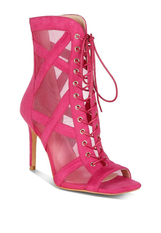 a pink high heeled shoe with a caged design