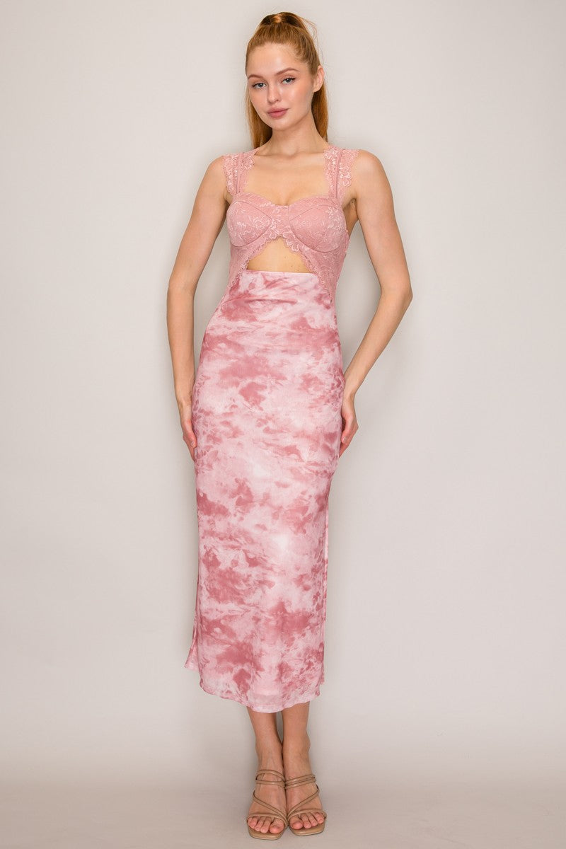 A woman modeling a pink dress with a lace crop cut out matching pink and white tie-dye dress