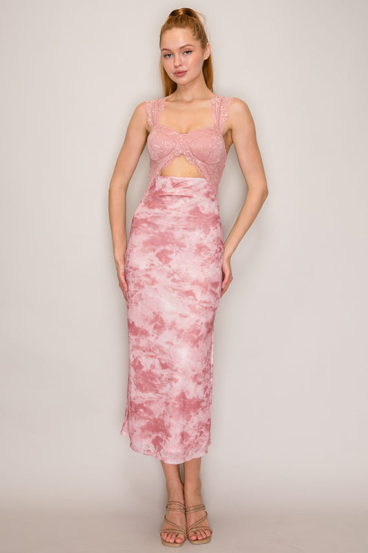 A woman modeling a pink dress with a lace crop cut out matching pink and white tie-dye dress