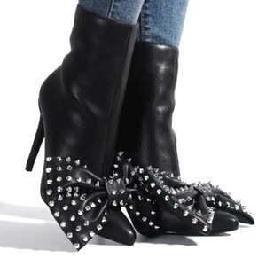 a pair of black high heeled shoes with white polka dots